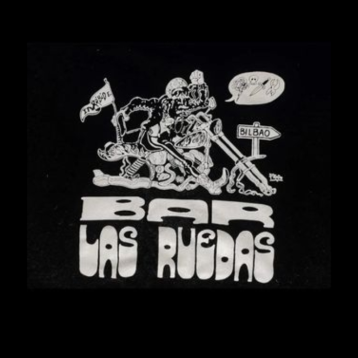 Logo blanco sobre fondo negro, arriba del logo hay un esqueleto motero montando una moto en direccion a Bilbao y bajo hay un lettering que hay escrito "Bar Las Ruedas"